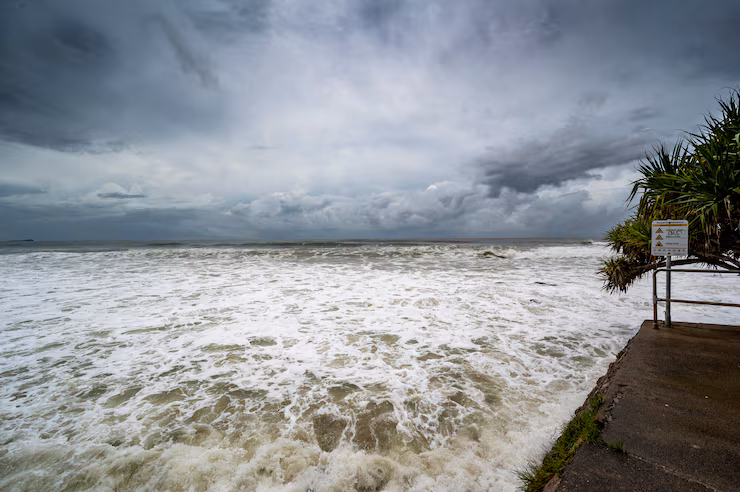 Florida homeowner preparing for hurricane season with storm shutters and supplies before June 1