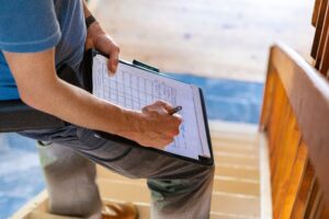Florida homeowner reviewing insurance claim documents considering whether to hire a public adjuster